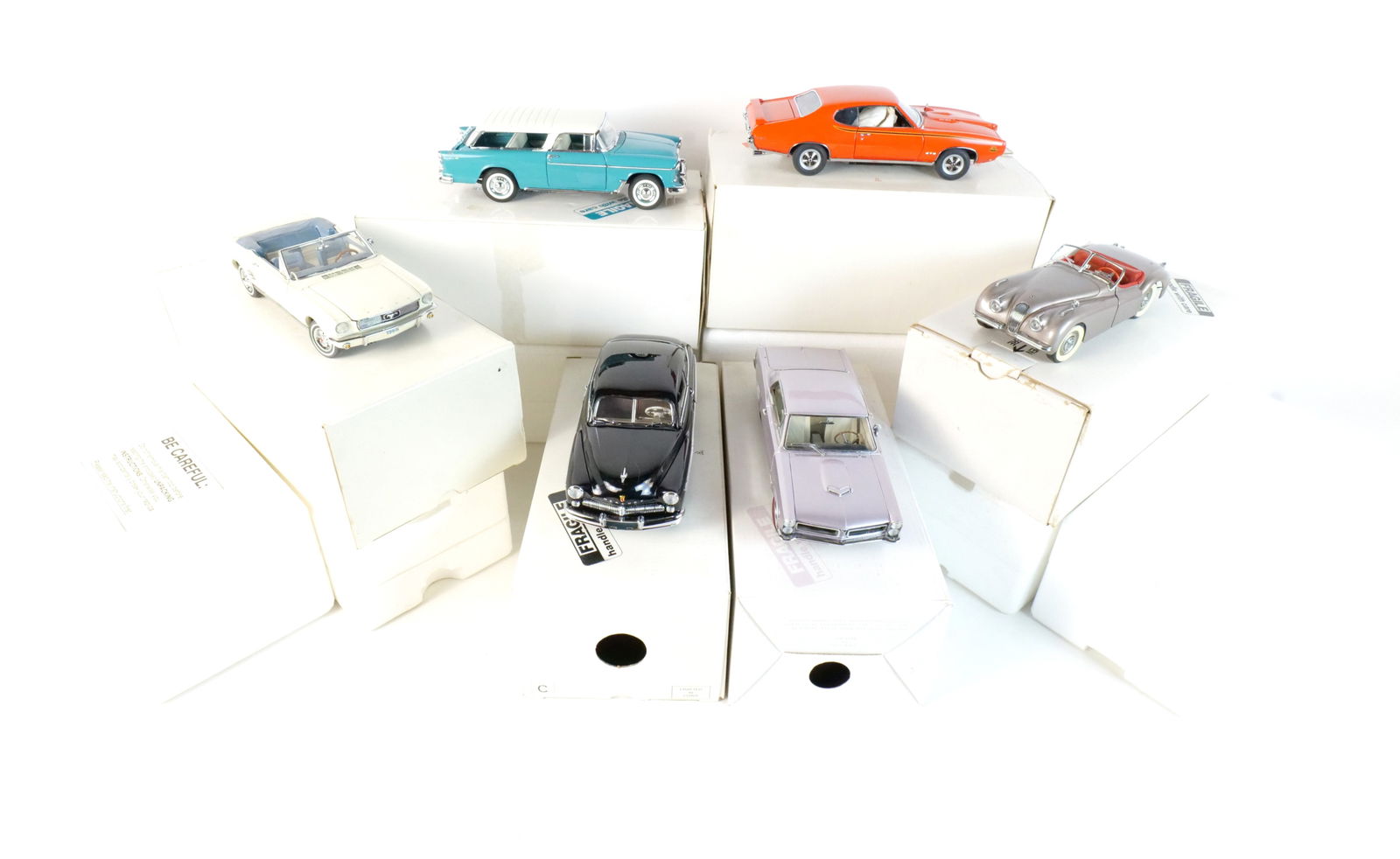Lot of 6 Danbury Mint Diecast Cars 1:24 Scale: Lot of 6 Danbury Mint Diecast Cars 1:24 Scale. Lot includes a Turquoise 1955 Chevrolet Nomad, a Silver 1965 Pontiac GTO, an Off-white 1966 Ford Mustang, an Orange 1969 Pontiac GTO Judge, a Black 1949