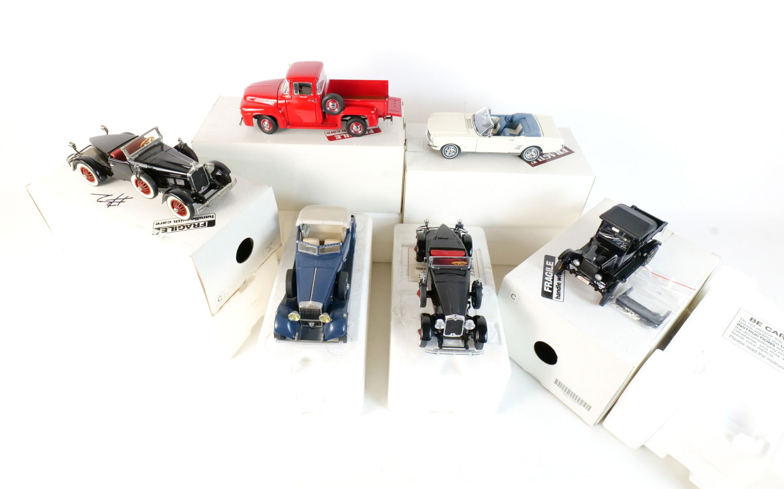 Lot of 6 Danbury Mint Diecast Cars 1:24 Scale: Lot of 6 Danbury Mint Diecast Cars 1:24 Scale. Lot includes a Black 1927 Stutz Black Hawk, an Off-white 1966 Ford Mustang, a Red 1956 Ford F-100 Pickup, a Black 1925 Ford Model T Runabout, a Black 192