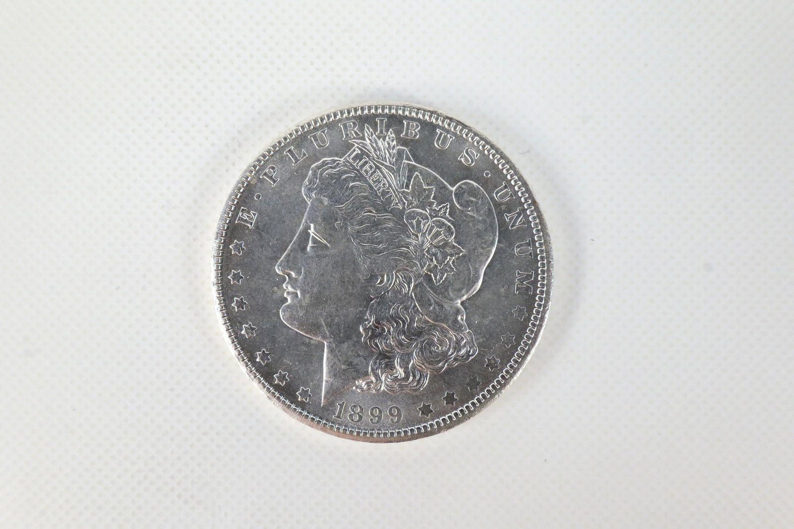 US 1899-O Morgan Silver Dollar: 1899-O Morgan Silver Dollar. In excellent condition. Catalog number: KM-110. Designer: George T. Morgan. New Orleans Mint. Design type: Liberty Head / Eagle. Mintage: 12,290,000. All invoices must be