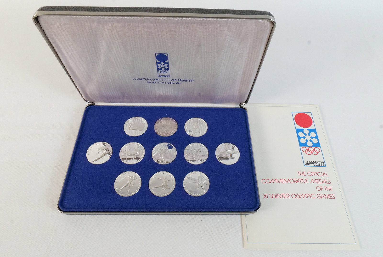 JP 1972 XI Winter Olympics Silver Proof Set, Franklin Mint: 1972 XI Winter Olympics Silver Proof Set. A collection of eleven silver commemorative medals minted by The Franklin Mint for the 1972 Sapporo Winter Olympic Games. Design types include winter sports a