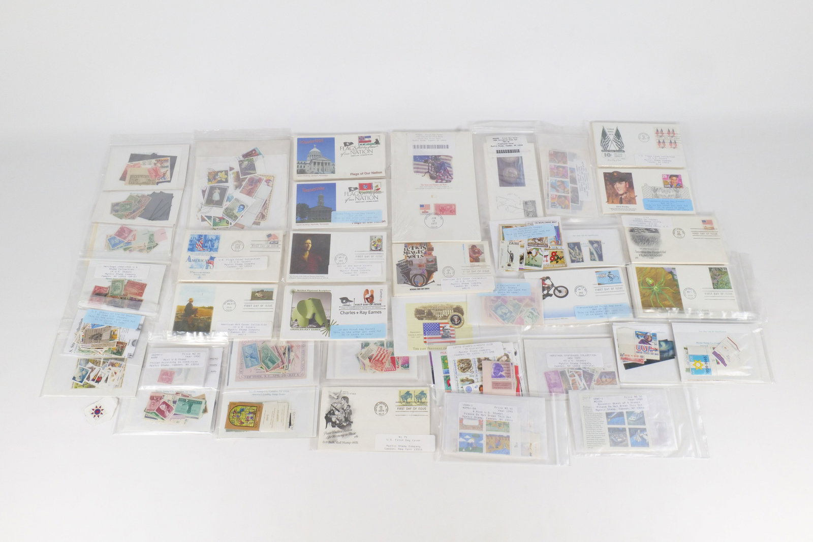 A Collection of US and International Stamps and First Day Covers: A comprehensive philatelic assembly featuring United States commemorative stamps, First Day Covers (FDCs), and international postal issues. The collection includes numerous Mystic Stamp Company retail