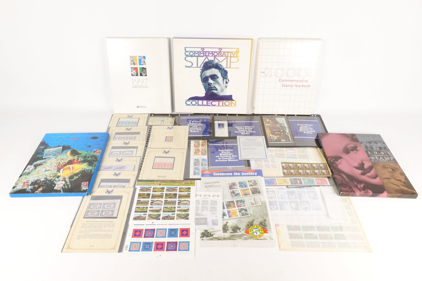A Collection of US and International Philatelic Yearbooks and Sheets: A Collection of US and International Philatelic Yearbooks and Sheets. This lot consists of five US Postal Service Commemorative Stamp Yearbooks for the years 1994, 1995, 1996, 1997, and 2000. US phila