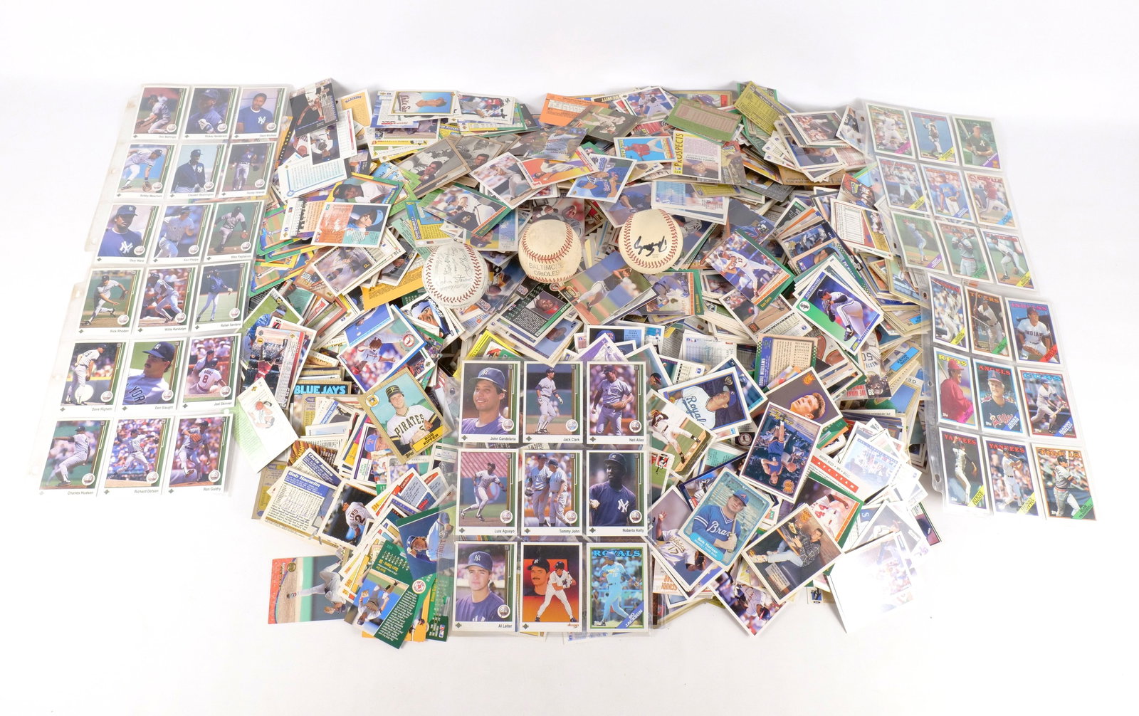 Huge Lot of Baseball Cards: Huge Lot of Sports Cards. Mainly Baseball from the 80's and 90's. Also includes 3 baseballs. One is a team ball with repligraphs, other is an Orioles ball with unknown light pencil signatures and last