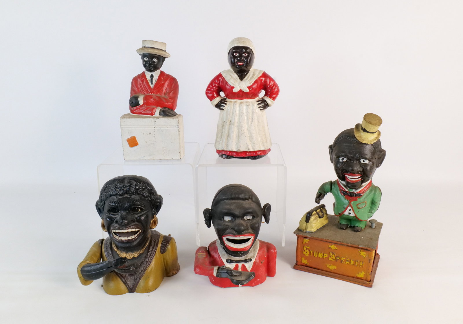 Lot of 5 Vintage Reproduction Cast Iron Banks: Lot of 5 Vintage Reproduction Cast Iron Banks. Including Dinah, Stump Speaker, Jolly Man, Mamma and Americana Bank. Tallest measures 10". All invoices must be paid within 24 hours of the sale. We offe