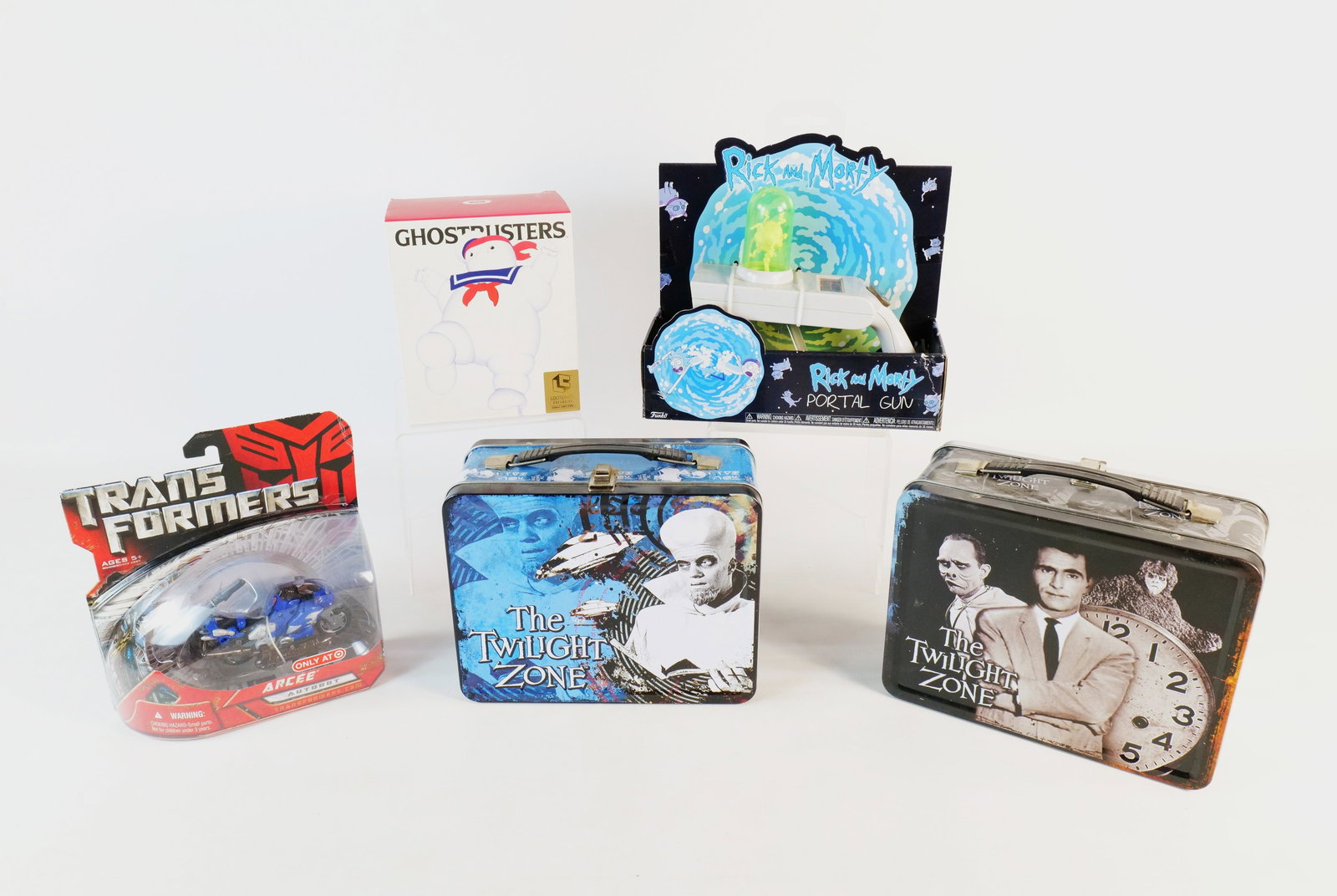 Lot of Pop Culture Collectibles and Toys: Lot of Pop Culture Collectibles and Toys. Including 2 different Bif Bang Pow Twilight Zone Lunchboxes, Transformers Arcee Autobot, Stay Puft Figure - Lootcrate, and Rick and Morty Portal Gun. All invo