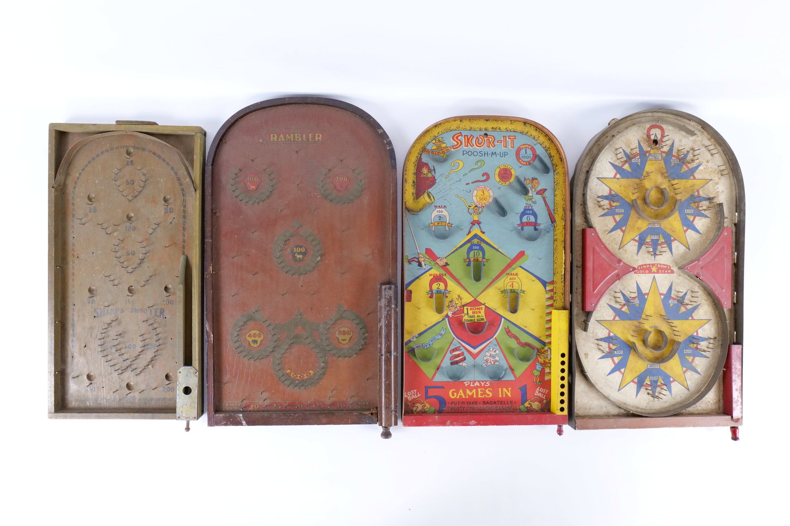 Lot of 4 Vintage/Antique Bagatelle Tabletop Pinball Games: Lot of 4 Vintage/Antique Bagatelle Tabletop Pinball Games. Circa 1930's-1950's. Including Lindstrom's Gold Star Art Deco Tin Litho Game, Northwestern Skor-It Poosh-M-Up - Nice Vibrant Graphics, Wooden