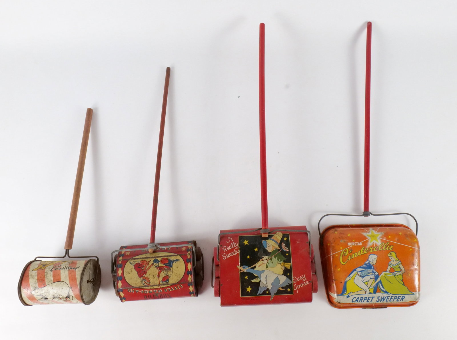 Lot of 4 Vintage Tin Litho Carpet Sweepers: Lot of 4 Vintage Tin Litho Carpet Sweepers. Including Norstar "Cinderella" Sweeper, Suzy Goose "Mother Goose" Sweeper by Kiddie Brush and Toy Co, Courtland Circus Cylinder Sweeper - Denting to the cyl