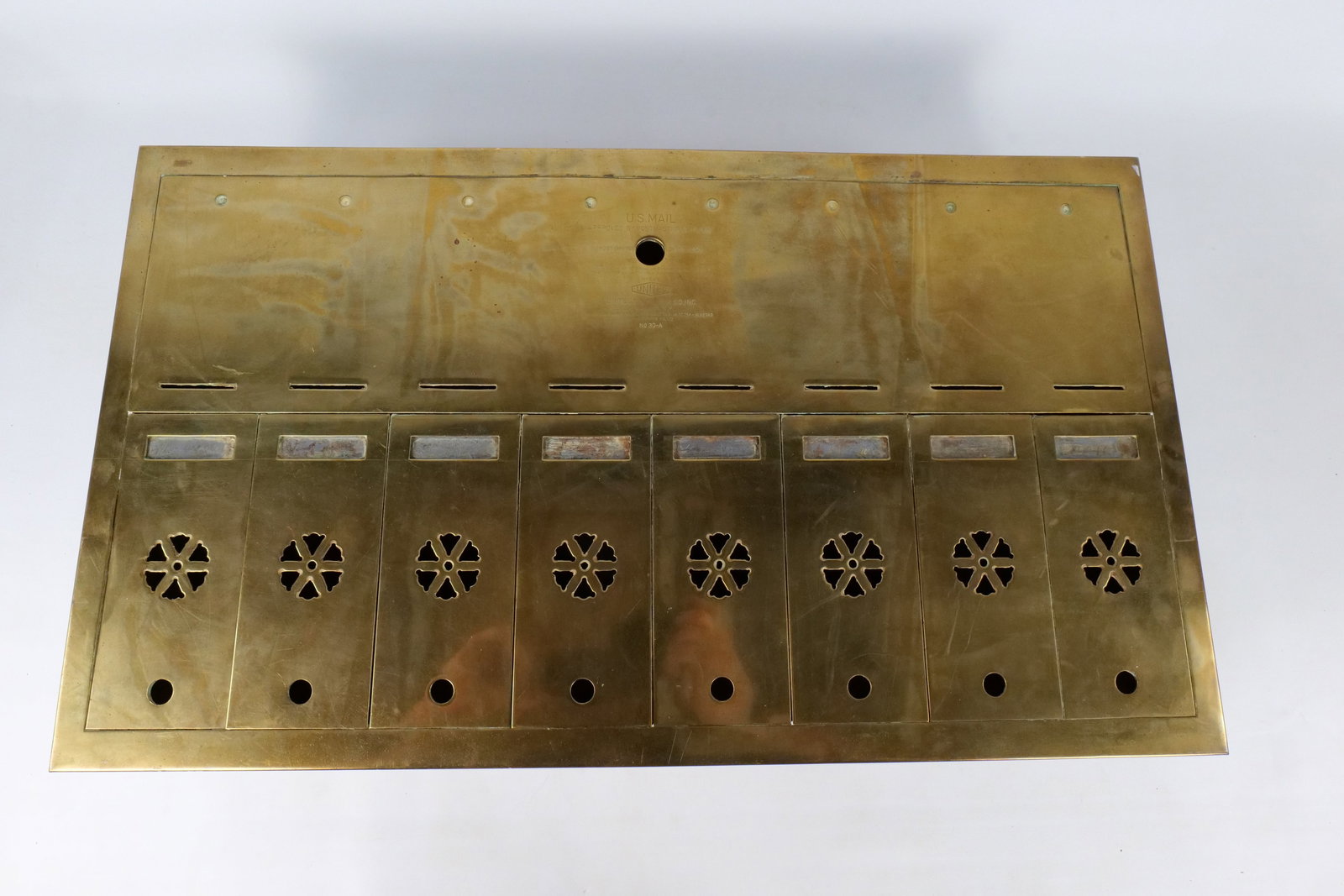 Vintage Brass 8-Door US Mail Apartment Mailbox: Vintage Brass 8-Door US Mail Apartment Mailbox. Circa late 20's/early 30's. Made by United Metal Box Co. Inc. Brooklyn N.Y. - Model 30-a. Solid Brass Faceplate with Metal Housing. Features 8 Individua