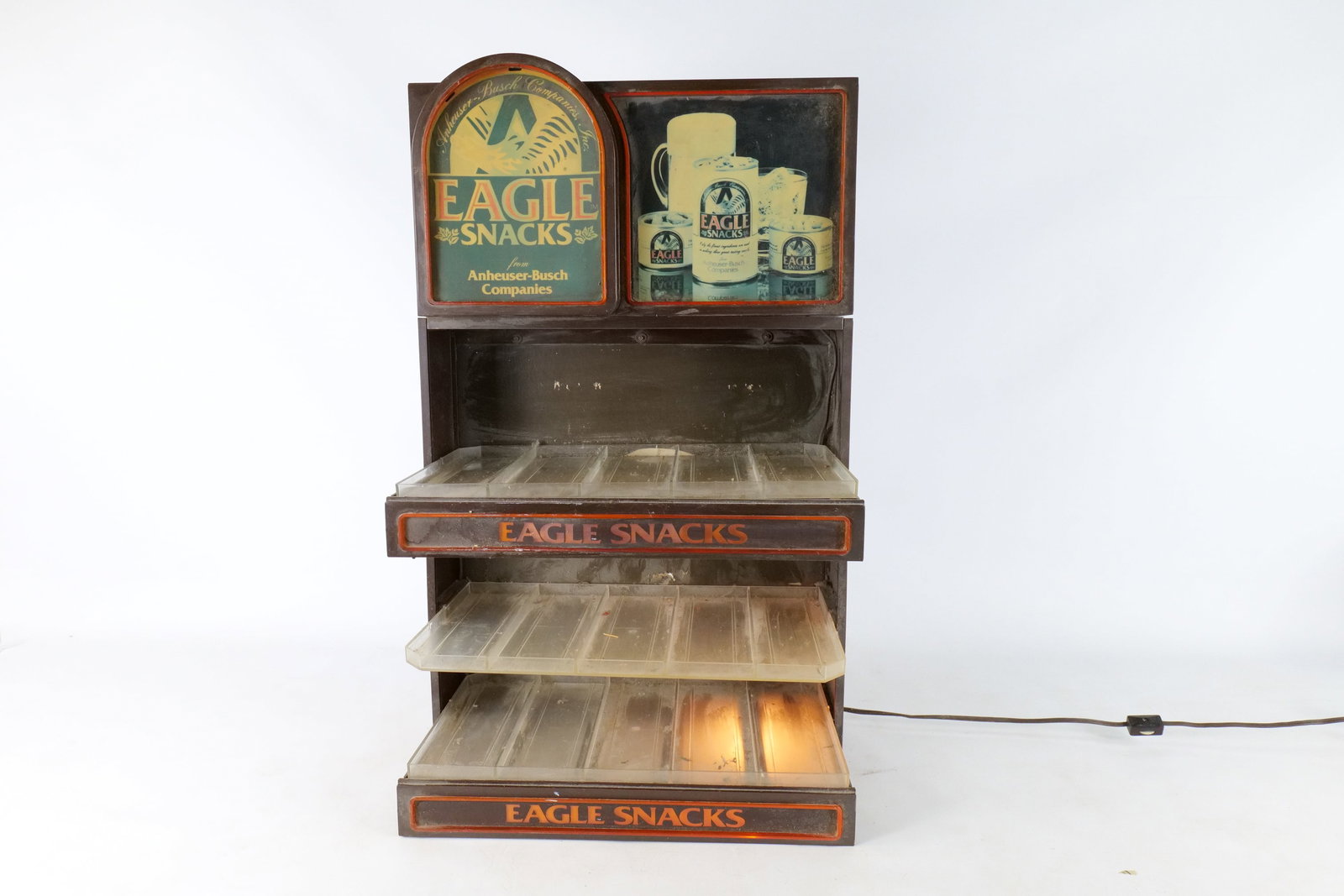 Vintage Eagle Snacks Light-Up Countertop Display Rack: Vintage Eagle Snacks Light-Up Countertop Display Rack - Anheuser-Busch Era. Plastic Housing with Clear Acrylic Tiered Shelving. Tested and Working. Some bulbs will need to be replaced. Shows some