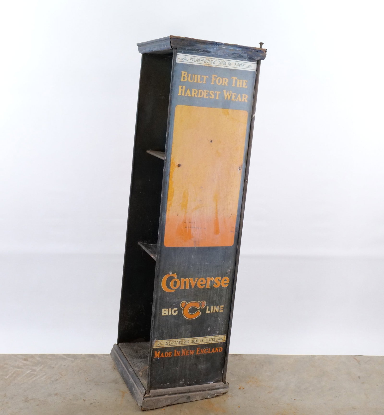 Antique 1920's Converse "Big C Line" Wood and Metal Display Cabinet: This tall, slender wooden and metal store display cabinet serves as an advertising piece for Converse footwear, specifically highlighting the Big C Line and Heavy Duty Footwear. The Cabinet features