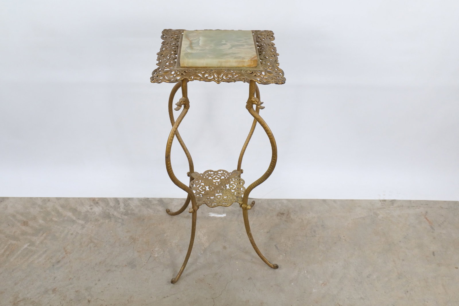 Victorian Style Brass & Green Onyx Pedestal Stand: Victorian Style Brass & Green Onyx Pedestal Stand. Heavy Ornate Brass with Rococo Scrollwork and Unique Serpent Legs. Some fleabite chips to the rim of the onyx. Measures 29.5" tall x 13.5" wide. All