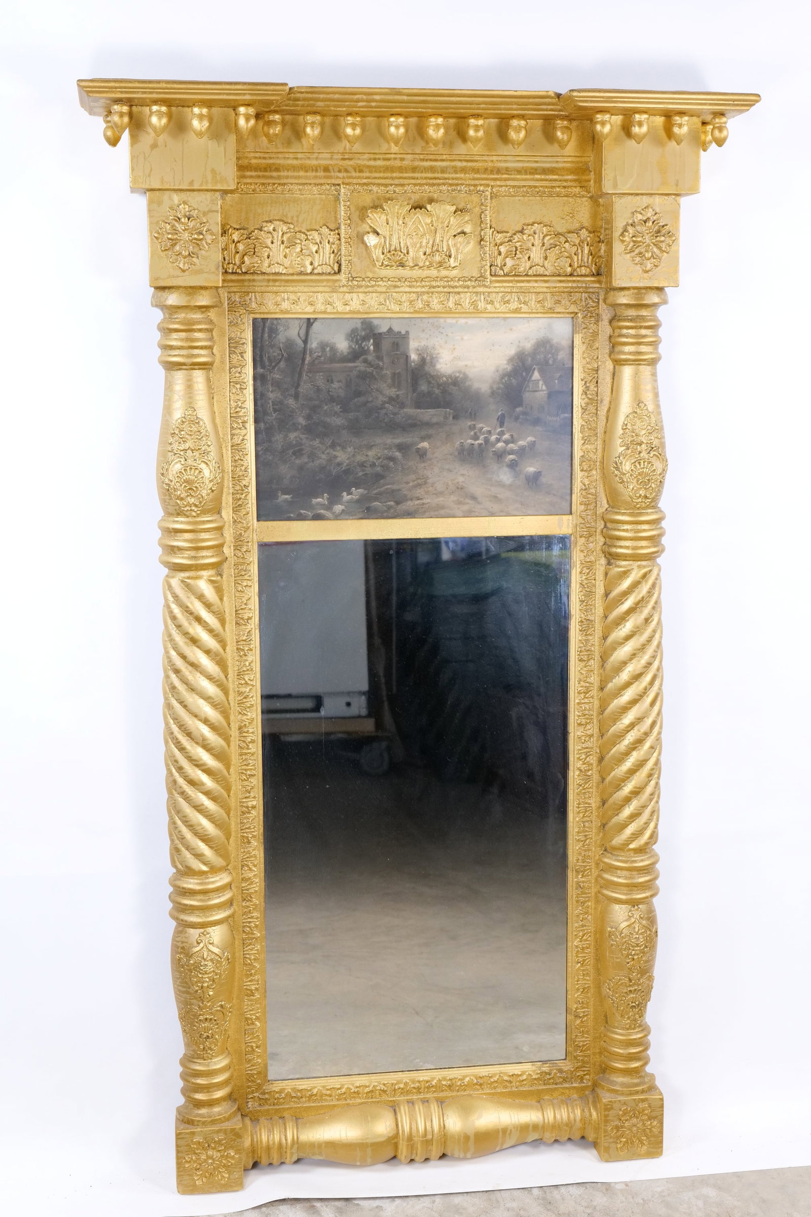 Antique Gilt Federal Style Pier Mirror with Pastoral Landscape Painting: Antique Gilt Federal Style Pier Mirror with Pastoral Landscape Painting - 19th Century. Painting depicts a shepherd with his flock near a country church. The frame is richly gilded wood with