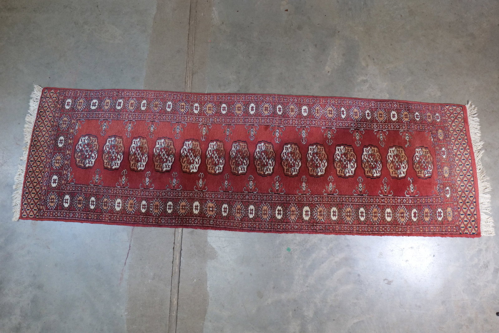 Vintage Hand-Knotted Bukhara Wool Runner - Classic Tekke Gul Pattern: Vintage Hand-Knotted Bukhara Wool Runner - Classic Tekke Gul Pattern. Pakistan 100% Wool. Iconic repeating Tekke Gul (Elephant Foot) octagonal medallions. Multi-Layered Geometric Borders. Excellent