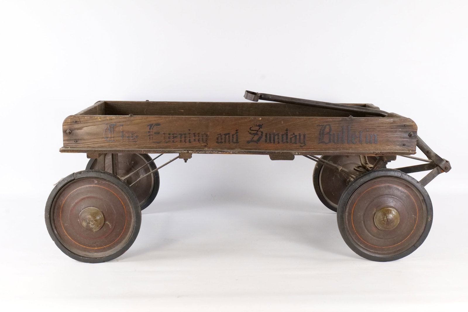 Vintage "The Evening and Sunday Bulletin" Wooden Newspaper Delivery Wagon: Vintage "The Evening and Sunday Bulletin" Wooden Newspaper Delivery Wagon - Philadelphia History. Circa 1946-1950. Features Classic Black Stenciled Old English Lettering on both sides. Heavy Duty Wood