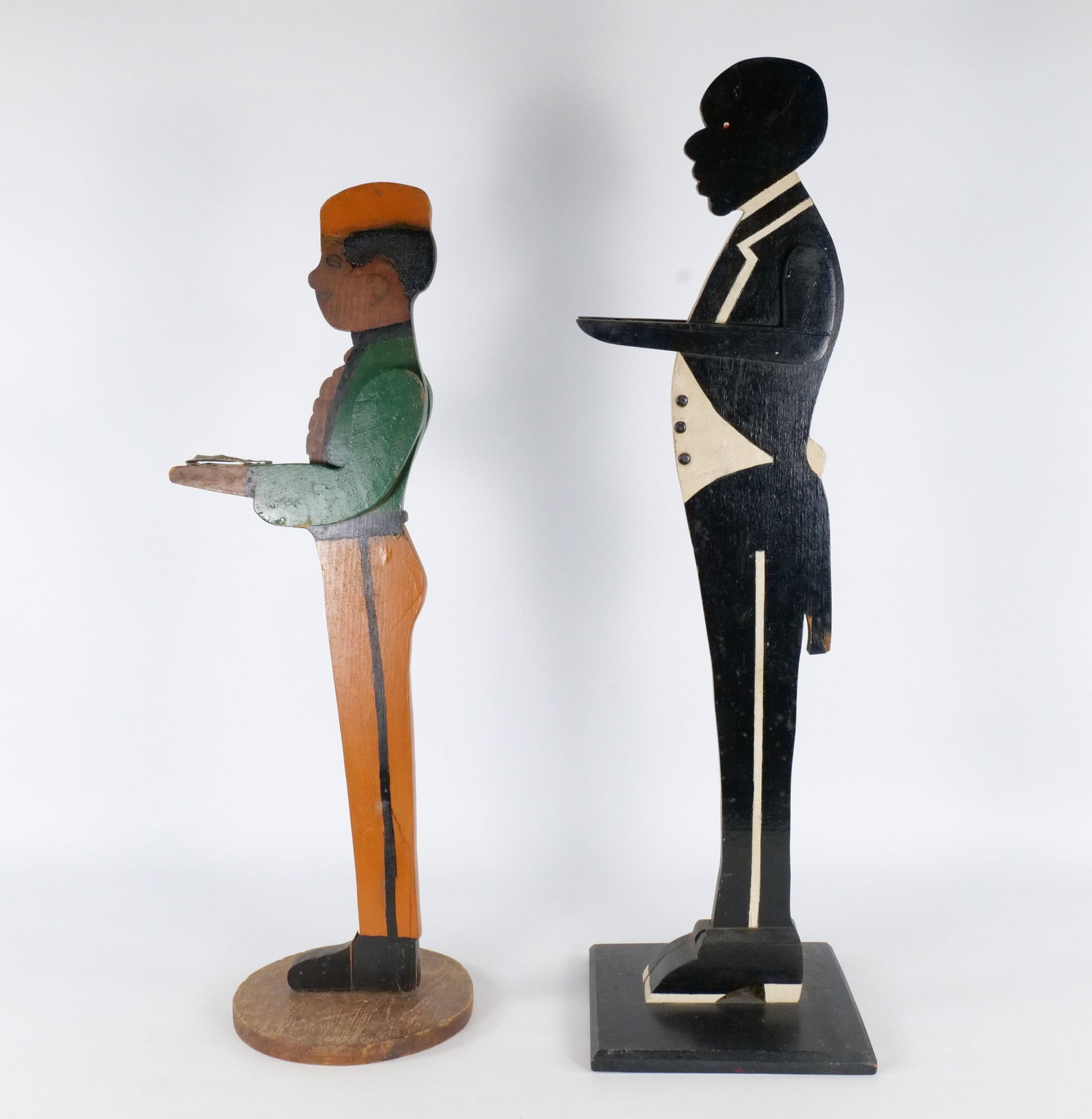 Pair of Vintage Hand Painted Wooden "Silent Butler" Figures: Pair of Vintage Hand Painted Wooden "Silent Butler" Figures. There is a visible crack at the base of the feet on the smaller figure. Noticeable paint loss. Some chipping on the base. Missing trays. Ta