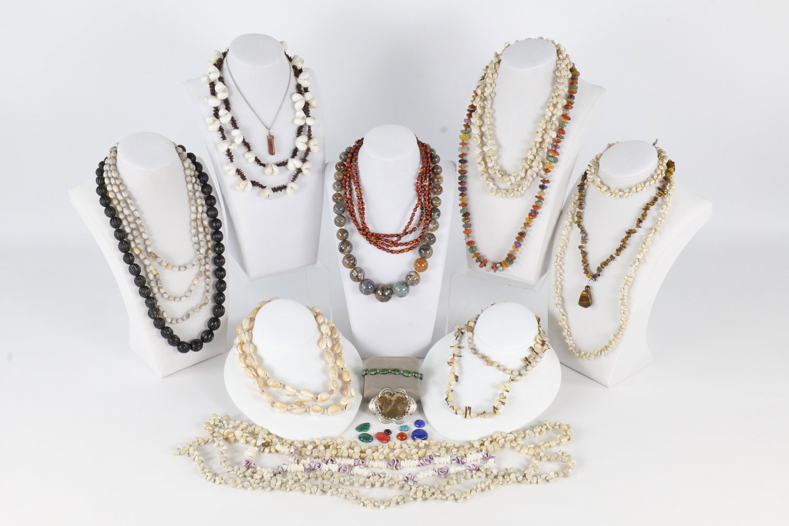 Lot of Natural Stone and Shell Necklaces: Large lot of natural stone and shell beaded necklaces. Also included are some cabochon loose stones. Included in this lot is a beautiful tiger's eye necklace. The largest round bead necklace is in fac