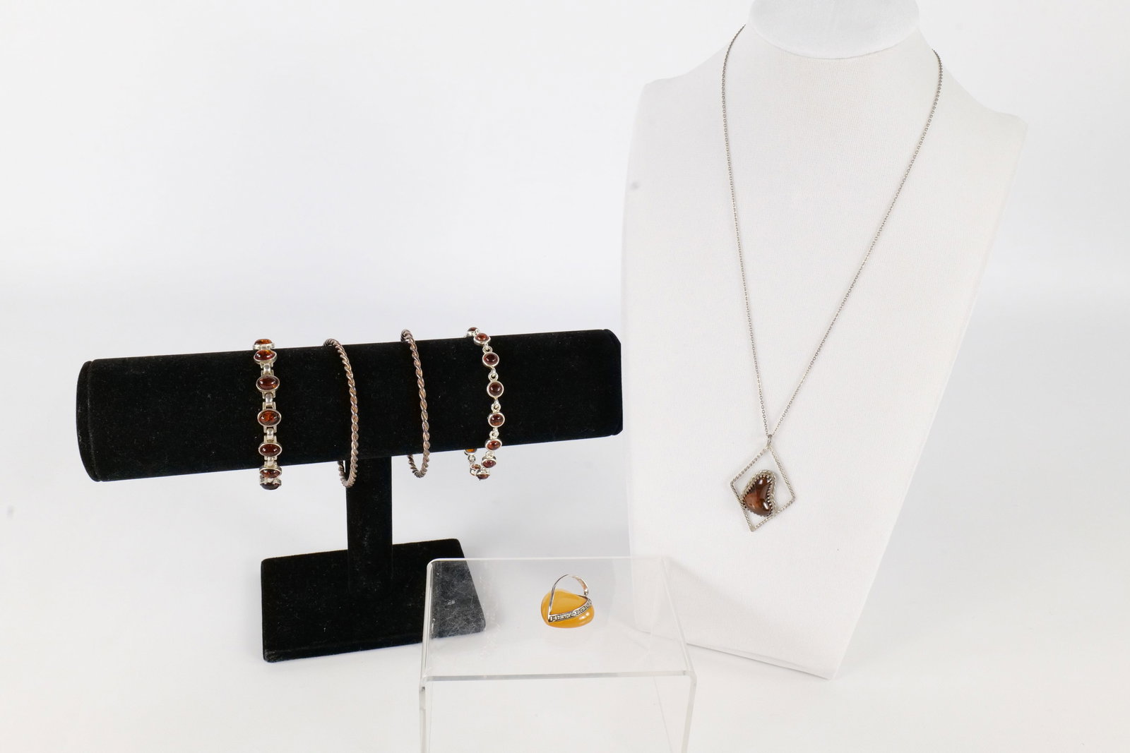 Lot of Sterling Jewelry: Lot of sterling silver jewelry including two cuff bracelets, a sterling and faux amber pendant on a non sterling silver chain, A sterling and amber necklace with Oval amber links, a sterling and faux 