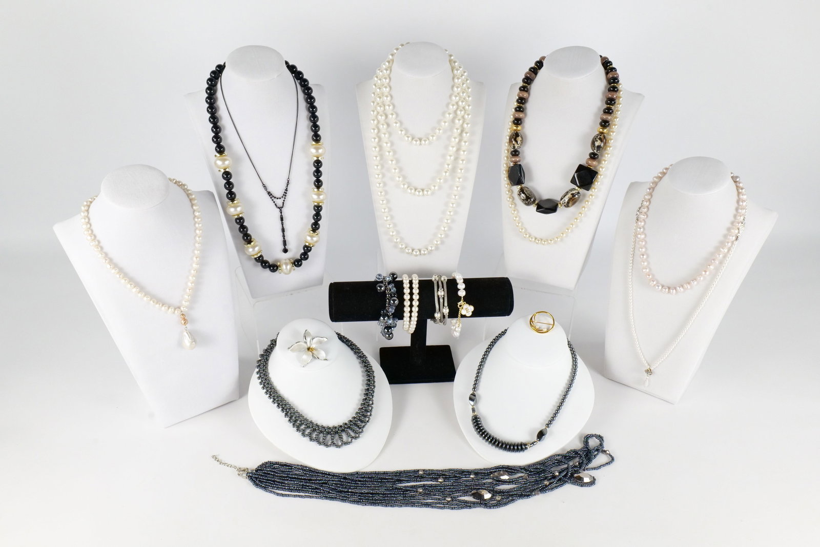 Lot of Costume Jewelry: Lot of assorted costume jewelry including Tang Yue simulated Pearl necklaces, Monet brooch, Anne Klein bracelet, beaded hematite necklace and more. All invoices must be paid within 24 hours of the sal