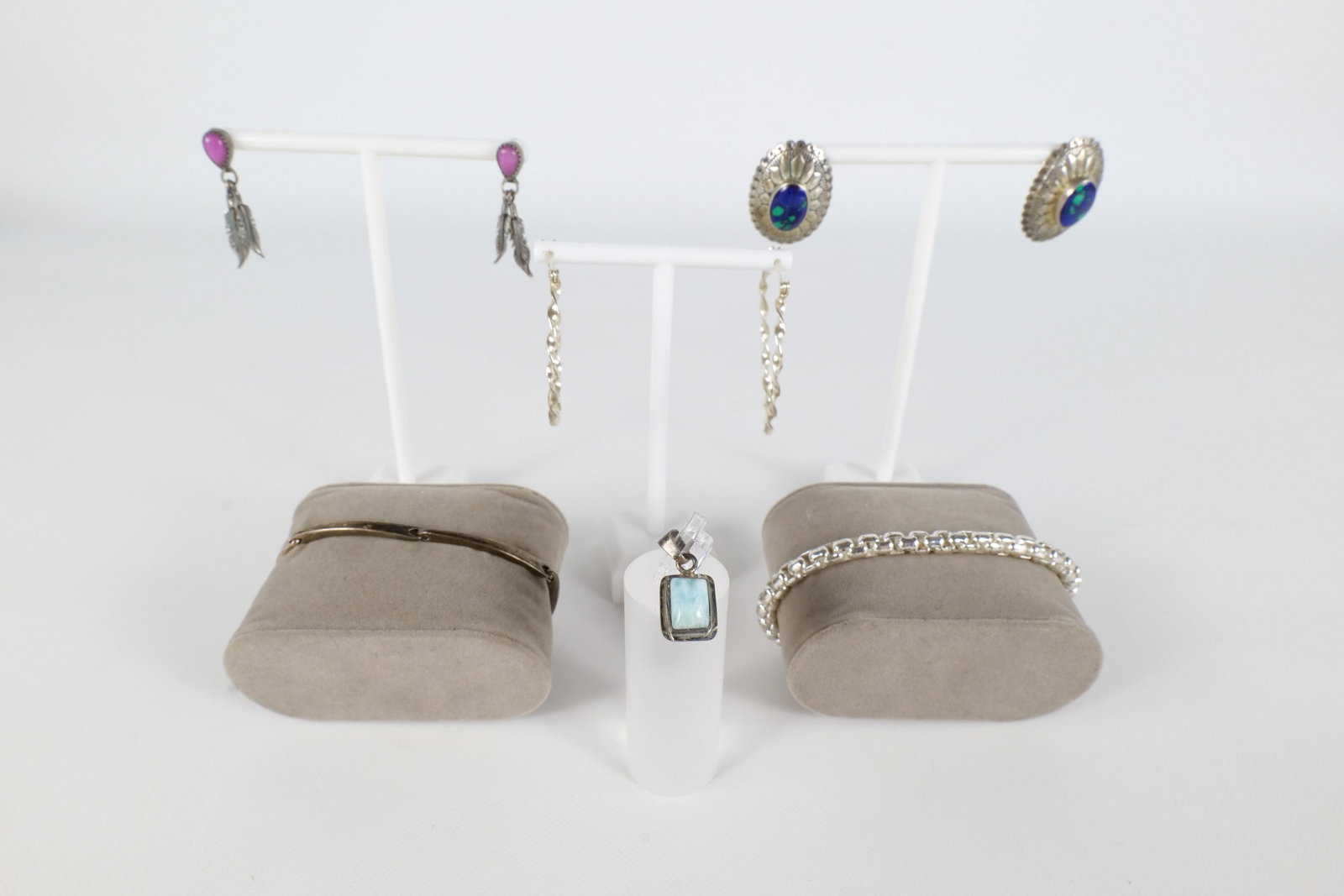 Lot of Sterling Jewelry: Lot of sterling silver jewelry including a pair of twisted hoop earrings, a thick link bracelet, a pair of sterling and azurite malachite earrings, a sterling link bracelet, a pair of feather earrings