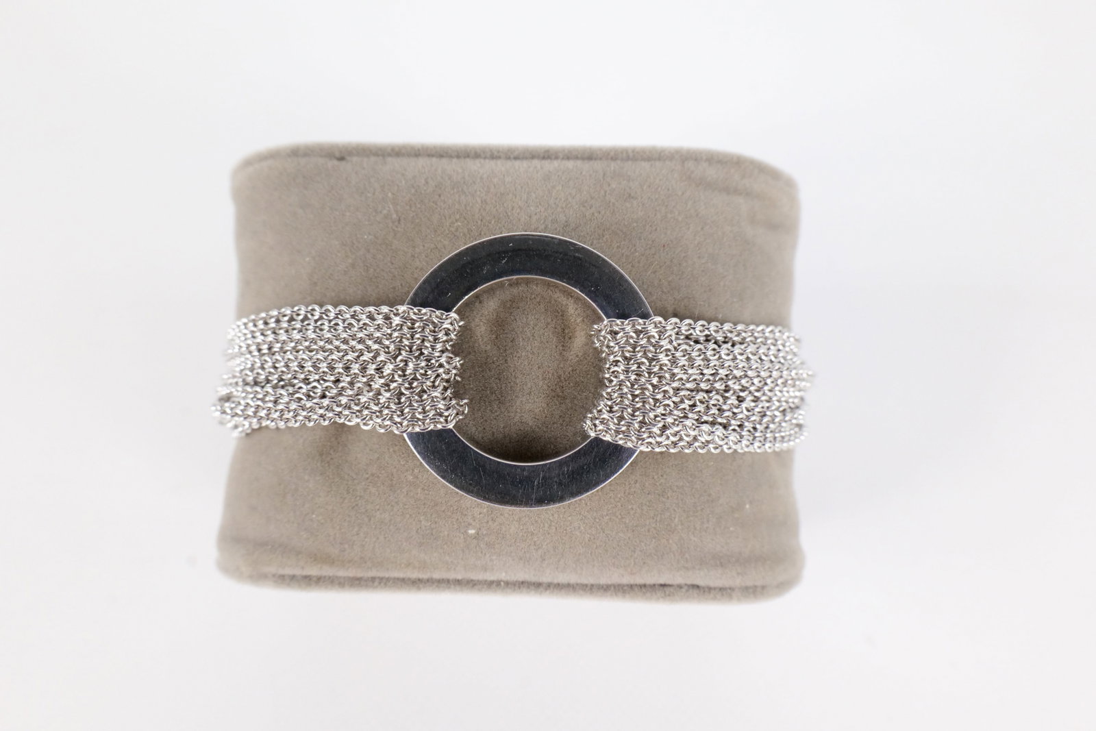 Movado Sterling Bracelet: A sterling silver Movado multi strand toggle link bracelet. The multi strands are joined together in the center by a heavy sterling circle. The bracelet measures approximately 7 1/2". All invoices mus