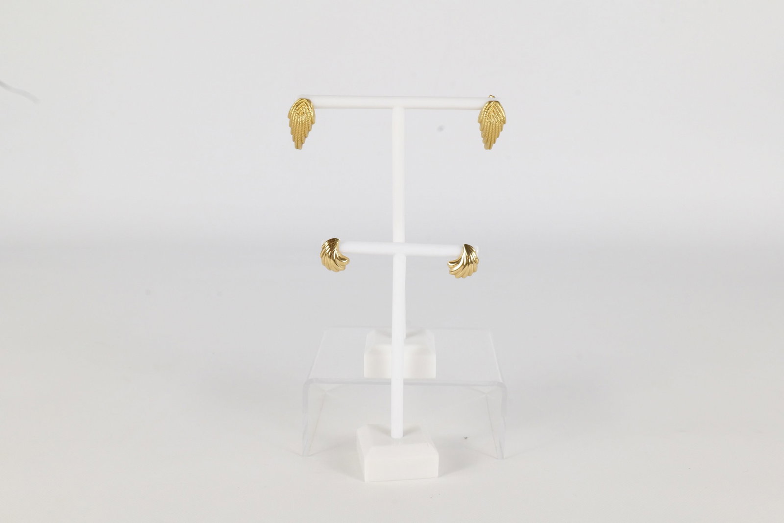 2 Pairs 14K Earrings: Two pairs of 14K earrings. The first is a swirl type pattern and is smaller than the 2nd. This pair was tested not marked. The 2nd pair is a leaf shape and is larger than the first period is marked