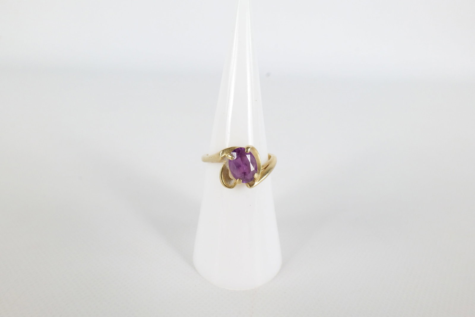 14K Amethyst Ring: A 14 K yellow gold and amethyst ring. Has a 7.9 mm oval amethyst in the center. Is marked Crosby 14 K inside the band. Size 5 1/4. All invoices must be paid within 24 hours of the sale. We offer