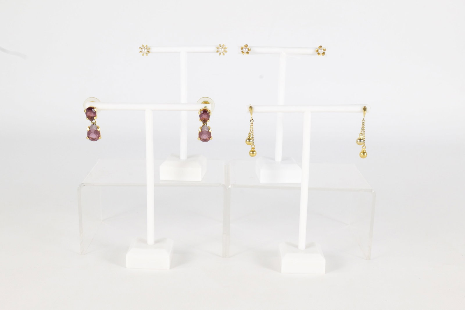 4 Pairs 14K Earrings: Four pairs of 14 K earrings including a pair of seed Pearl and 14 K sunburst posts, a pair of seed Pearl and flower 14 K posts, a pair of drop earrings with balls on the ends that are 14 K post only,