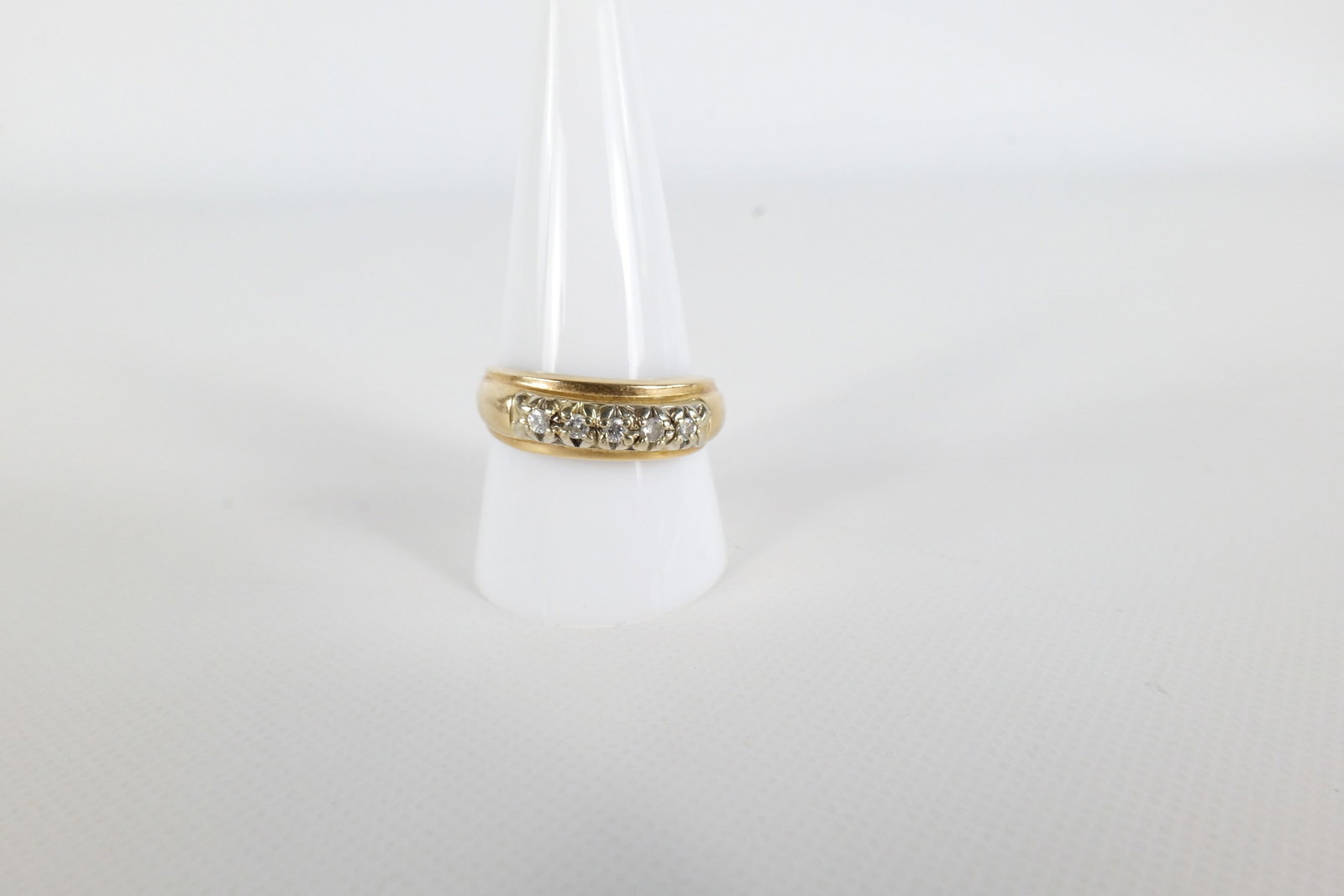14K & Diamond Men's Ring: 14 K yellow gold and Diamond men's ring. Has a row of small diamond chips along the front. Is marked on the inside of the band. Size 10 1/4. All invoices must be paid within 24 hours of the sale. We o