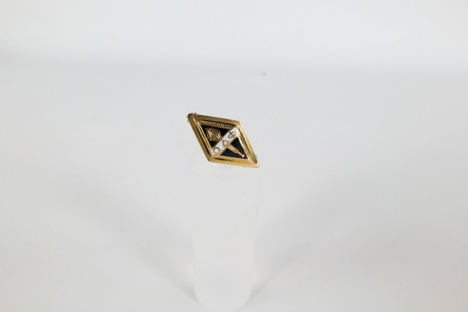 14K Fraternal Pin: 14 K yellow gold and enamel fraternal Pen. Pin has black and white enamel along the front, and is inscribed on the back G OZ. Was tested is not marked. It does not appear that the pin bar is gold. Wei