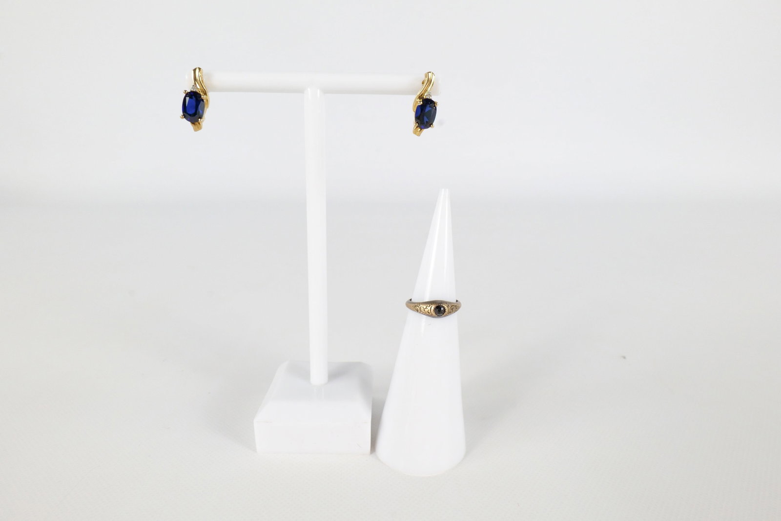 Lot of 10K Jewelry: Lot of 10 K gold jewelry including a 14 K white gold child's ring with a small round garnet. Has decorative engraving along the front. Was tested as not marked. Also included is a pair of 10 K yellow 