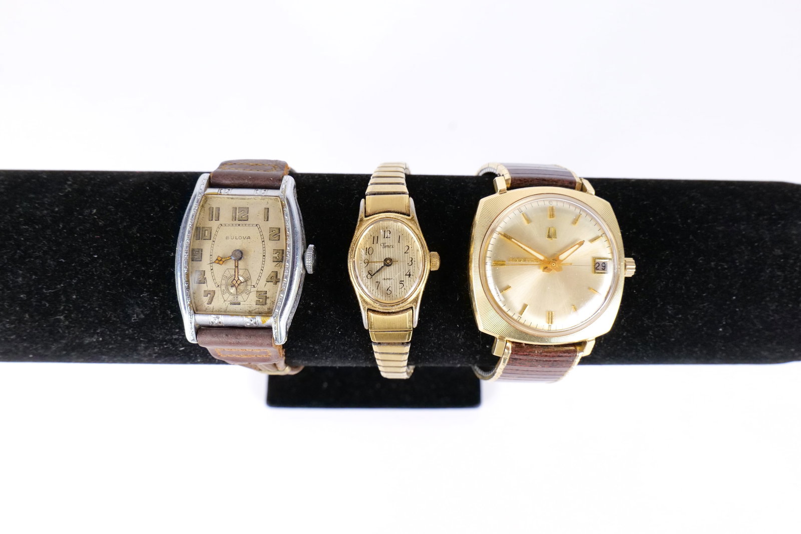 Lot of Watches: A small lot of watches including a ladies Timex stainless steel, A 14 K gold filled case Bulova Accutron men's watch And a 14 K rolled gold plate Bulova men's watch in white gold. They measure 4 1/2" 