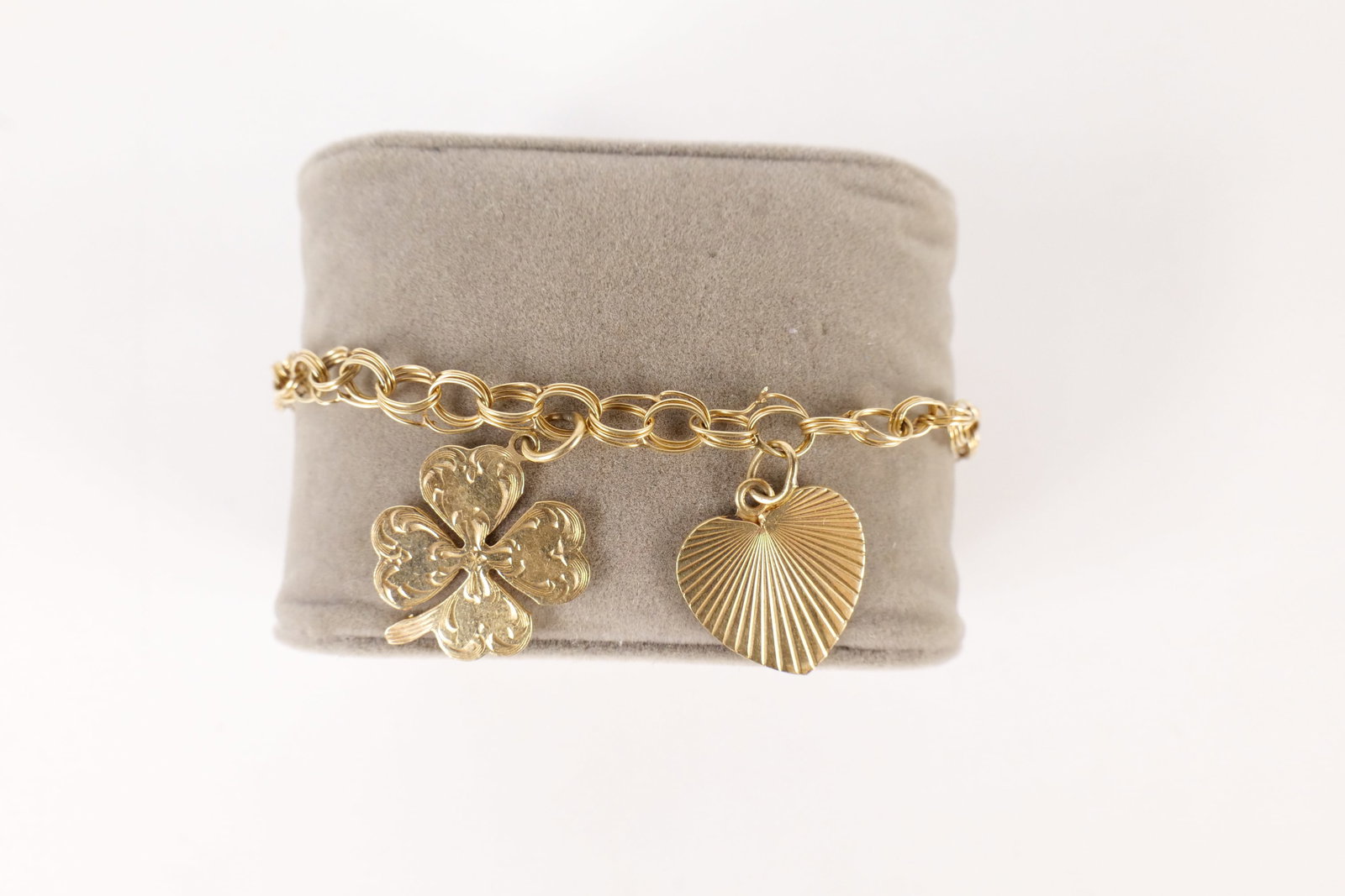 14K Charm Bracelet: 14k Charm Bracelet. Measures 6.25" long. Contains shamrock and heart. Weighs approx. 6.6g. Both charms and the bracelet are marked. All invoices must be paid within 24 hours of the sale. We offer mult