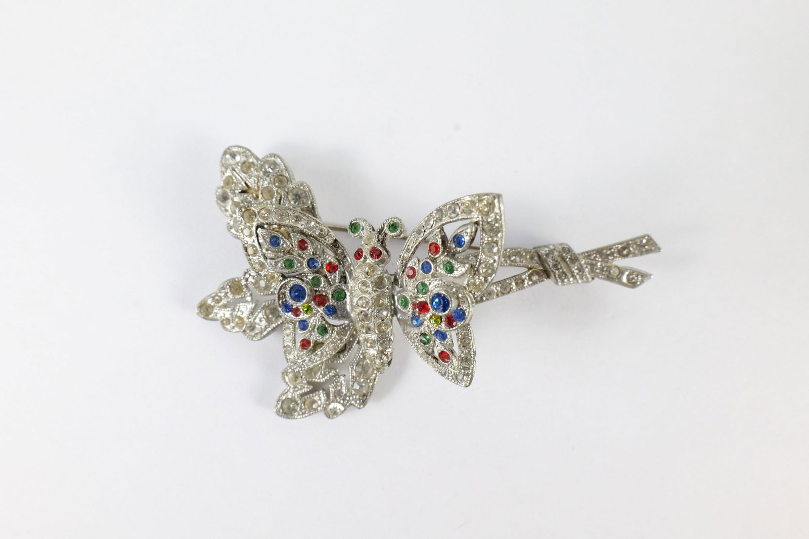 Vintage Coro Pin: Vintage Coro Butterfly and Leaf Trembler Brooch Pin. Jewel Tone with Rhinestones. Measures 3" long. Clear stones are a little discolored. All invoices must be paid within 24 hours of the sale. We offe