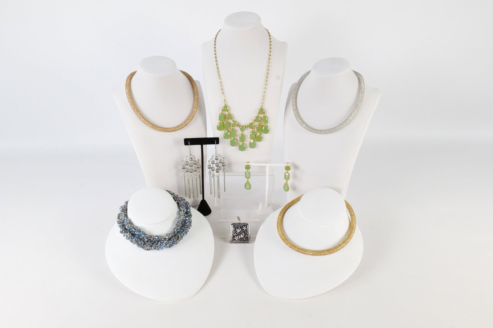Lot of Costume Jewelry: Lot of costume jewelry including a Swarovski Stardust mesh necklace trio, a Kate Spade jade green necklace and earring set, a damascene bird pendant, ball and chain chandelier earrings, a twisted bead