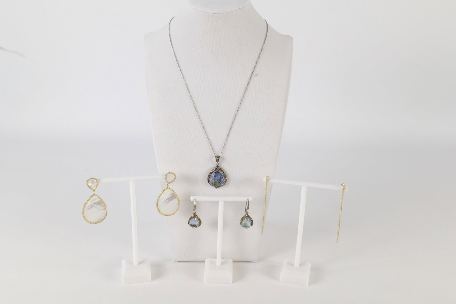 Lot of Sterling Jewelry: A lot of sterling silver jewelry including a sterling chain with an abalone sterling and marcasite pendant and matching earrings. Are marked SLC 925. Also included is a pair of sterling mother of Pear