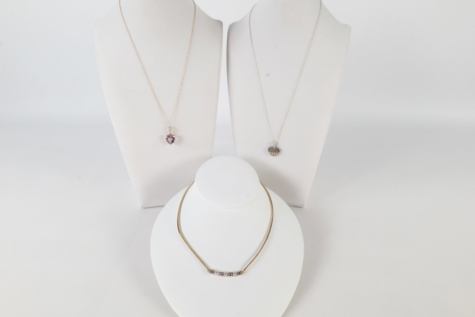 Lot of Sterling and Gemstone Jewelry: Lot of sterling silver and gemstone jewelry including a gold tone sterling necklace with sapphires and small diamond chips on the front, rose gold tone sterling silver necklace with a pink topaz heart