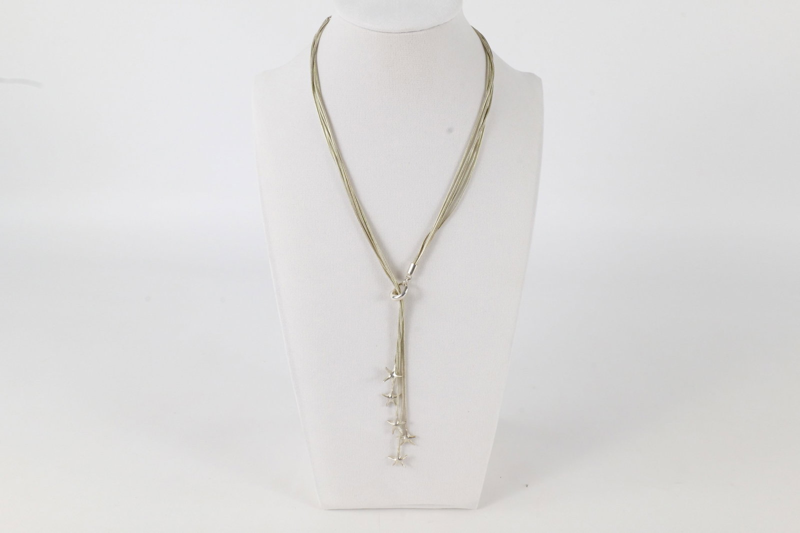 Sterling Starfish Necklace: A liquid Sterling multi strand necklace with multiple starfish at the end of each chain that slides through a loop. Is marked on a tag near the clasp. Measures approximately 17". All invoices must be 