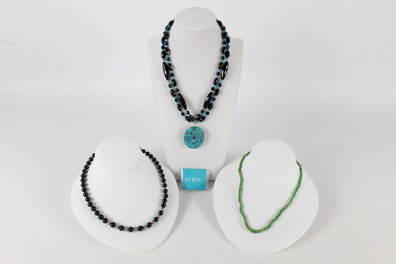 Lot of Jay King Jewelry: Lot of Jay King jewelry including a black chalcedony and turquoise Necklace with turquoise spacers and a pressed turquoise pendant that has been etched into a flower with a sterling clasp. Also includ