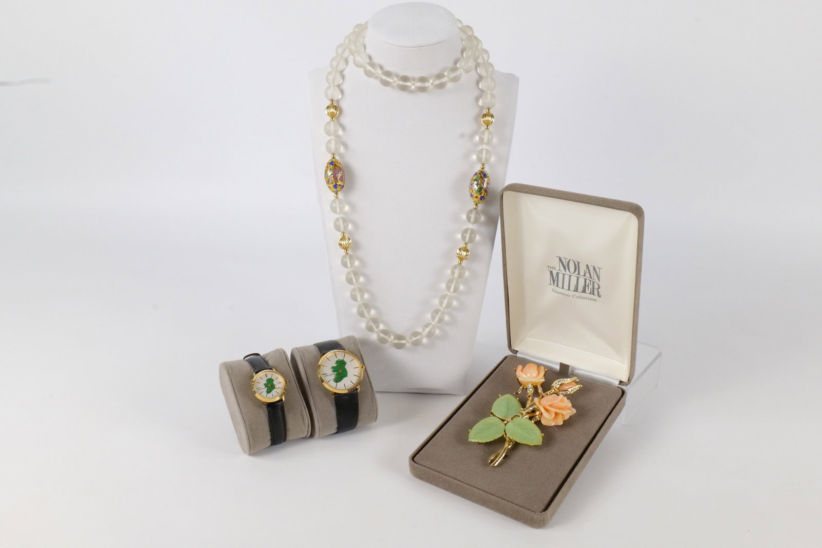 Lot of Costume Jewelry: Lot of costume jewelry including 2 Ireland wristwatches - a man's and a woman's, a clear bead and Cloisonne necklace, and a Nolan Miller glamor collection simulated coral and Jadeite flower pin with r