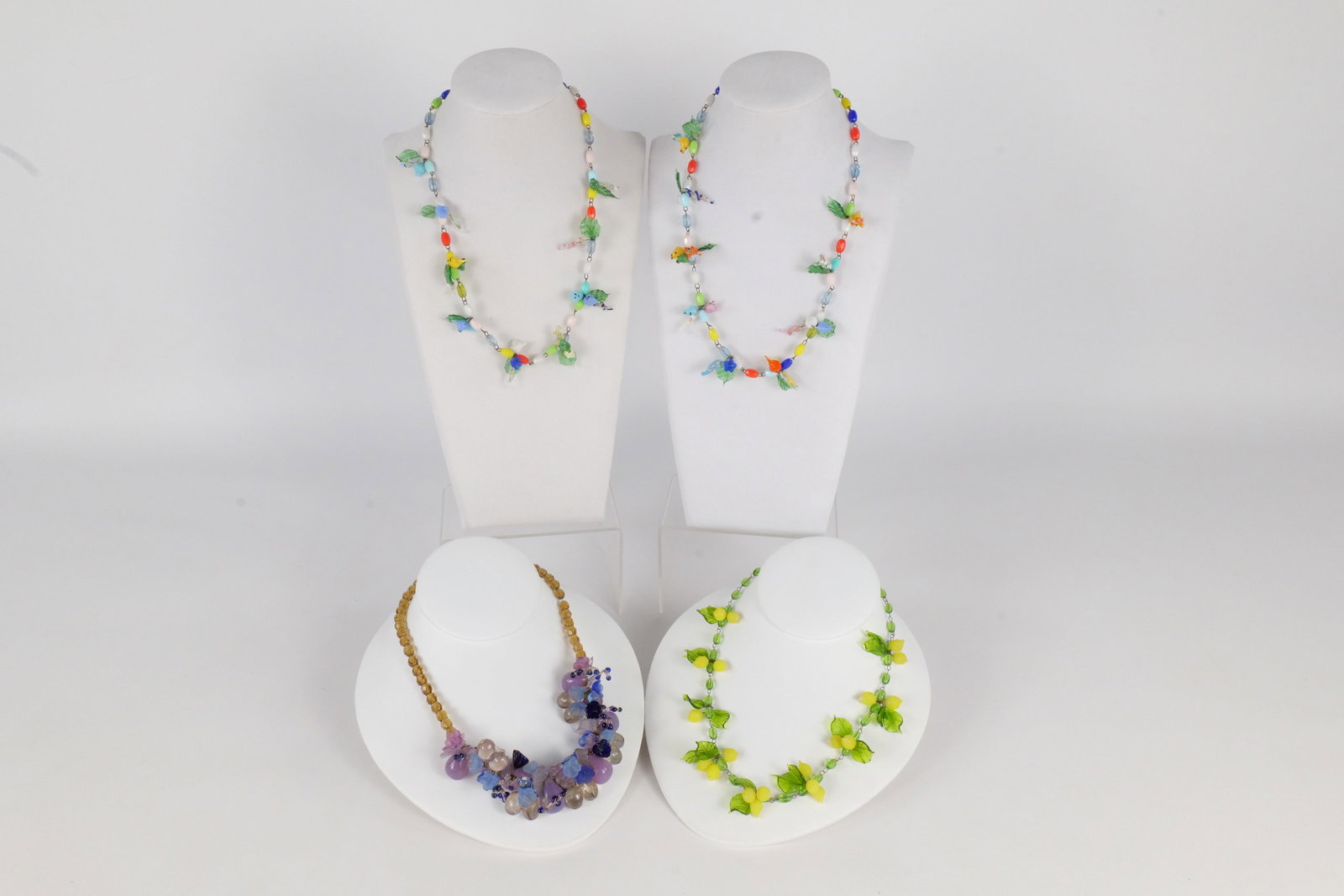 Lot of 4 Vintage Glass Beaded Necklaces: Lot of 4 Vintage Glass Beaded Necklaces. Two have bird and leaves design, one has lemons and leaves design, and other has flowers designs. Longest measures 18". All invoices must be paid within 24 hou