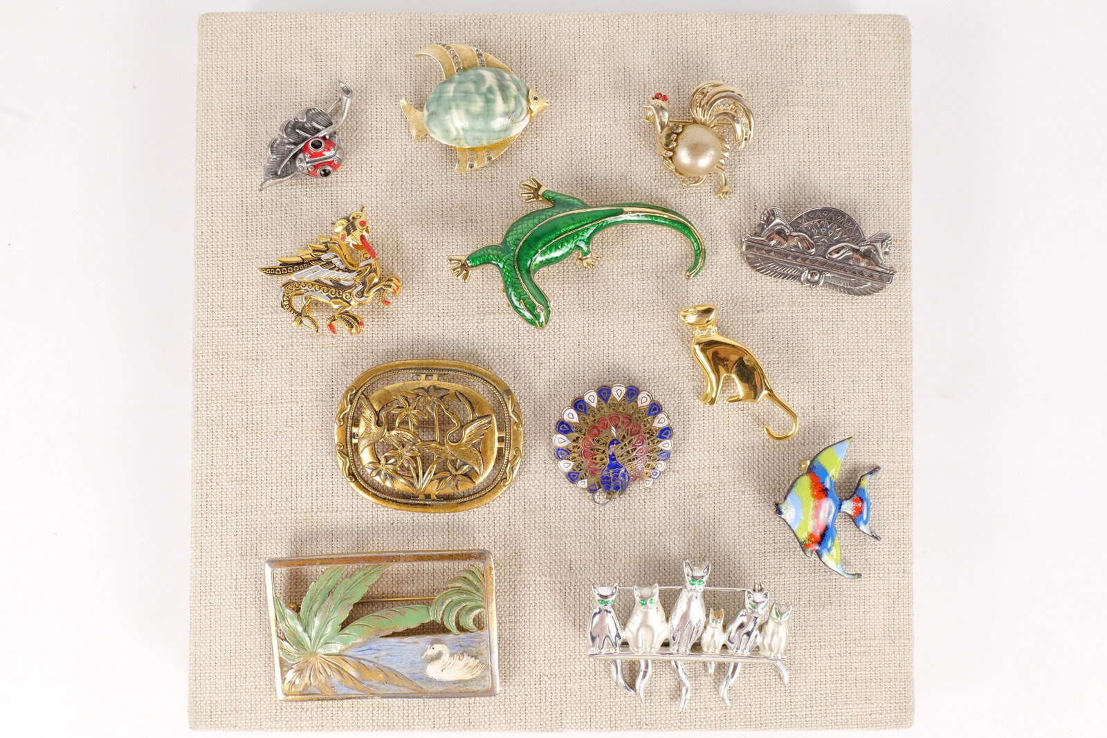 Lot of Vintage Pins: Lot of Vintage Pins. Including Cats with Moving Tails, Lizards, Birds, Fish, Dragon, and Swan. Deco, Enamel, and Brass. Fish and Rooster missing stones. Some stones are discolored. Largest measures 2.
