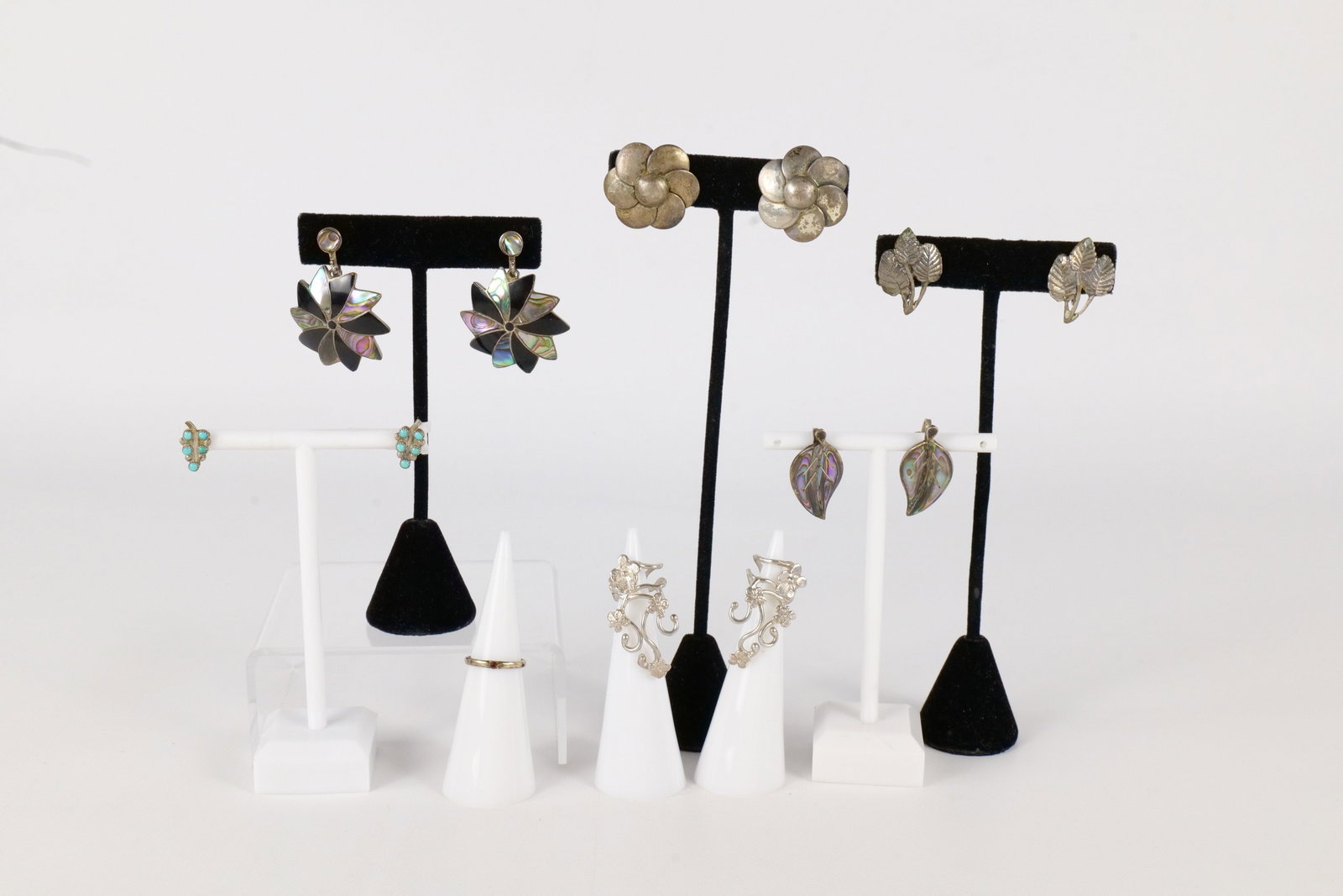 Lot of Sterling Jewelry: Lot of Sterling Jewelry. Including 4 Pairs of Screw Back Earrings - 2 Pairs set with Abalone, Pair of Pierced Earrings Set with Turquoise, Child's Size 3 Ring, and 2 Ear Cuffs. Stud Earrings missing b