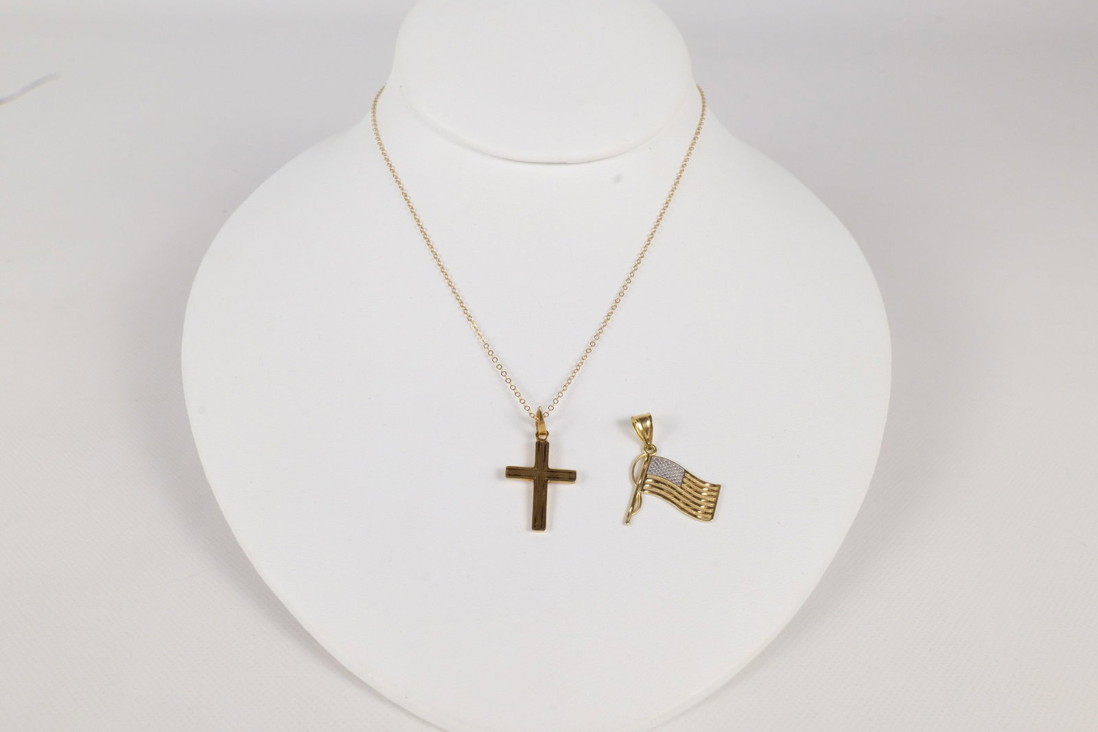 14k Cross on Dainty Chain and Flag Pendant: 14k Cross on Dainty Chain and Flag Pendant. All Marked. Weighs 2.6 grams. Chain measures 16". All invoices must be paid within 24 hours of the sale. We offer multiple shipping options, please read