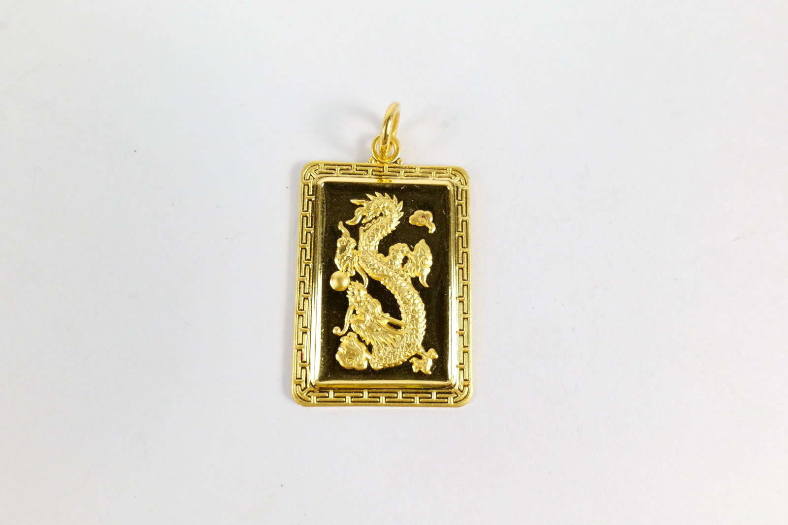 24k Dragon Pendant: 24k Dragon Pendant - Rectangular shaped with dragon in center of frame. Character of blessing or good fortune. Marked 1.25". Weighs 13.8 grams. All invoices must be paid within 24 hours of the sale. W