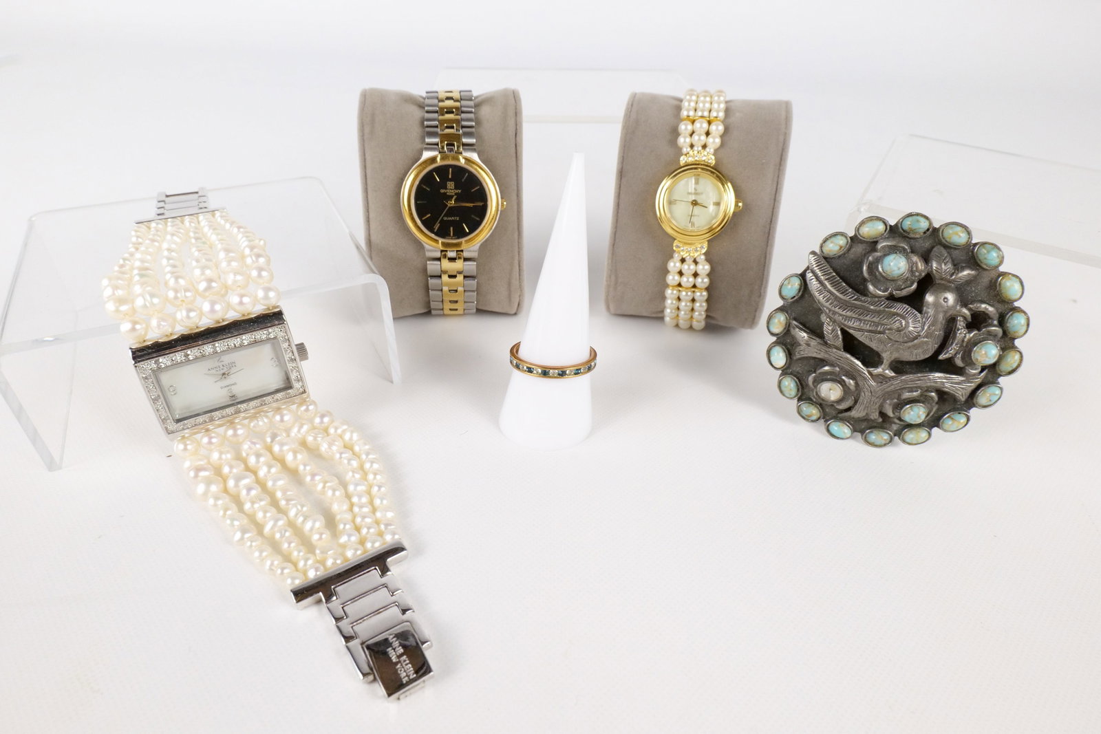 Lot of Costume Jewelry and Womens Watches: Lot of Costume Jewelry and Womens Watches. Including Silver tone SW Buckle - Missing Stone, Anniversary Band Sz 9, Anne Klein Watch with Simulated Pearls, Peugeot Watch with Simulated Pearls, and Give