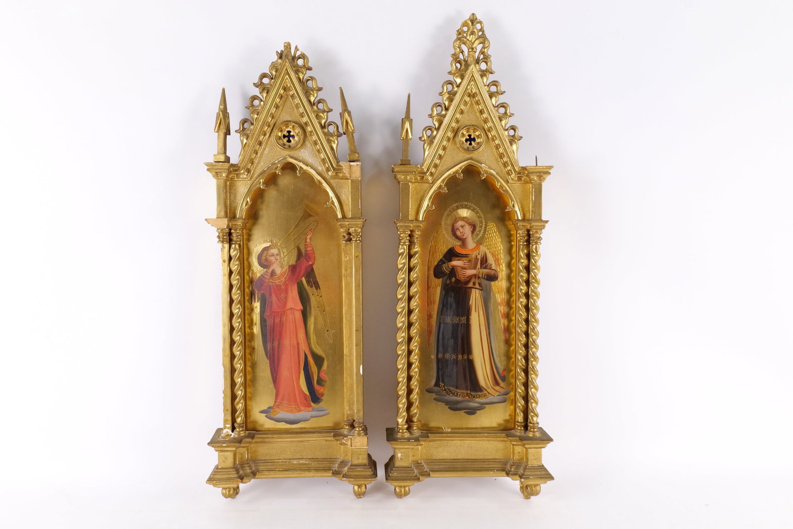 Pair of Antique Gothic Revival Angel Icons: Pair of Antique Gothic Revival Angel Icons. One features and angel with lyre and other is an angel playing a trumpet. Frames are AS-IS. Some pieces are included. Measures 31" tall x 10.5" wide. All in