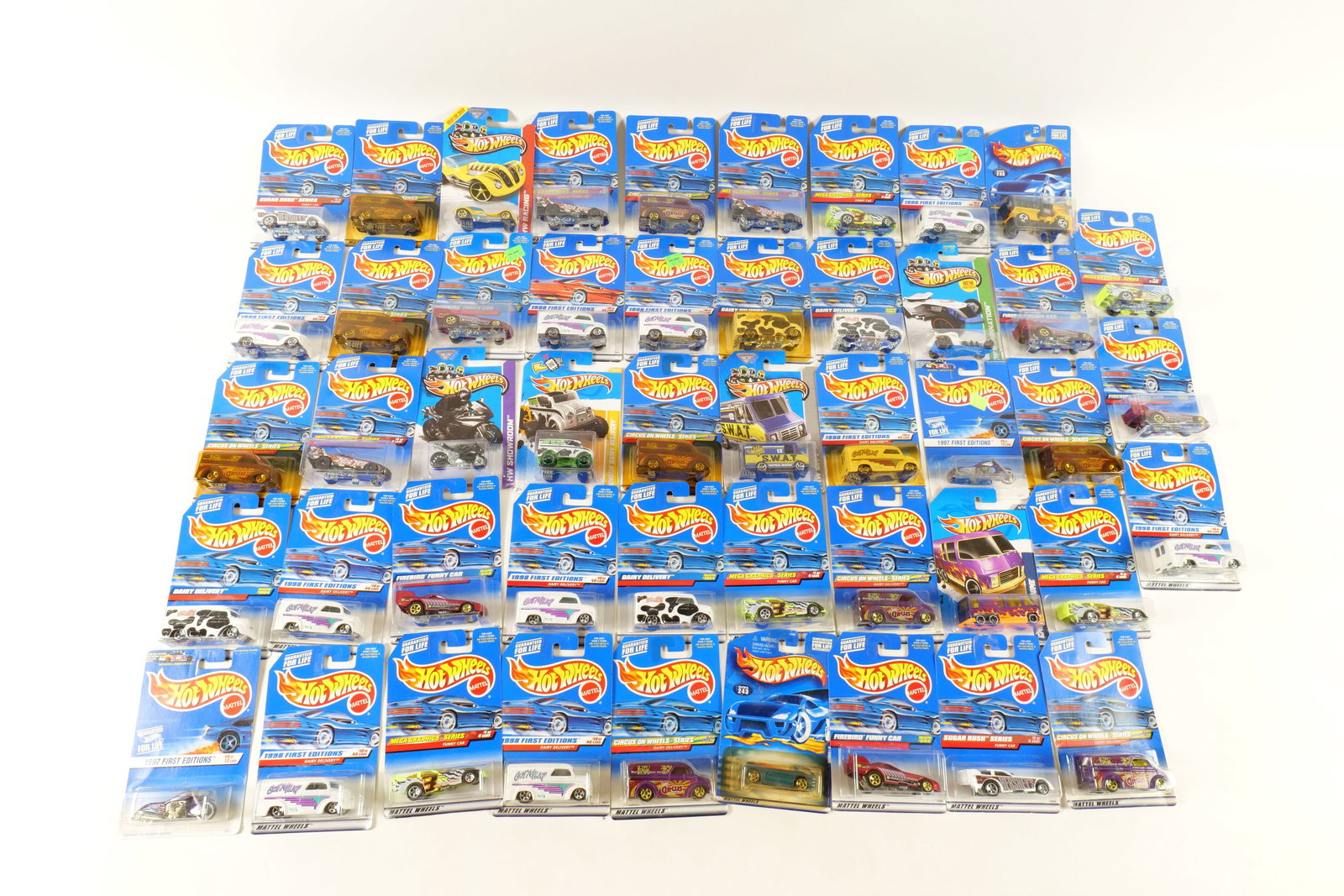 Lot of 50 Carded Hot Wheels: Lot of 50 Carded Hot Wheels. Including Dairy Delivery, Ducati 1098R, Firebird Funny Car, GMC Motorhome, Monster Dairy Delivery and More. Includes some duplicates. Some of the cards have some wear. All