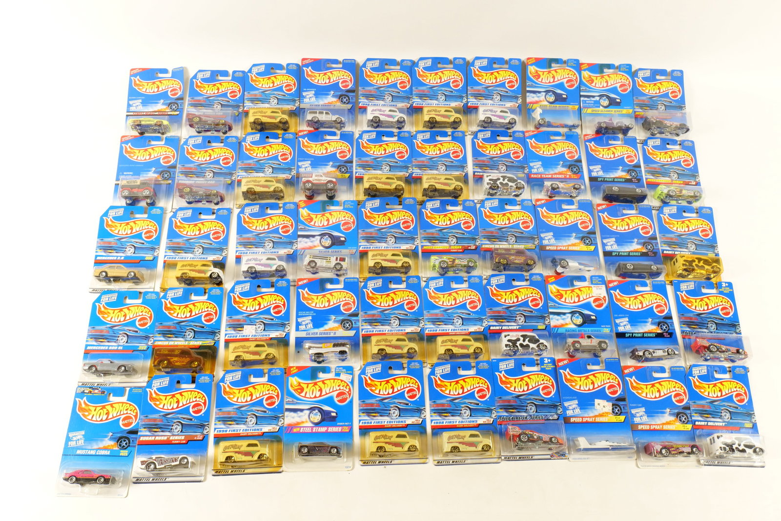 Lot of 50 Carded Hot Wheels: Lot of 50 Carded Hot Wheels. Including Dairy Delivery, Funny Car, Mustang Cobra, Mercedes Benz Unimog, T-Bucket, Custom Corvette, and More. Includes some duplicates. Some of the cards have some wear. 