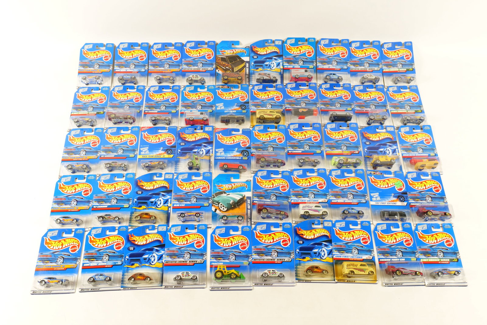 Lot of 50 Carded Hot Wheels: Lot of 50 Carded Hot Wheels. Including '63 Corvette, Pit Crew Truck, VW Bug, '67 Camaro, Firebird Funny Car, '80's Corvette, Hyper Mite, and More. Includes some duplicates. Some of the cards have some