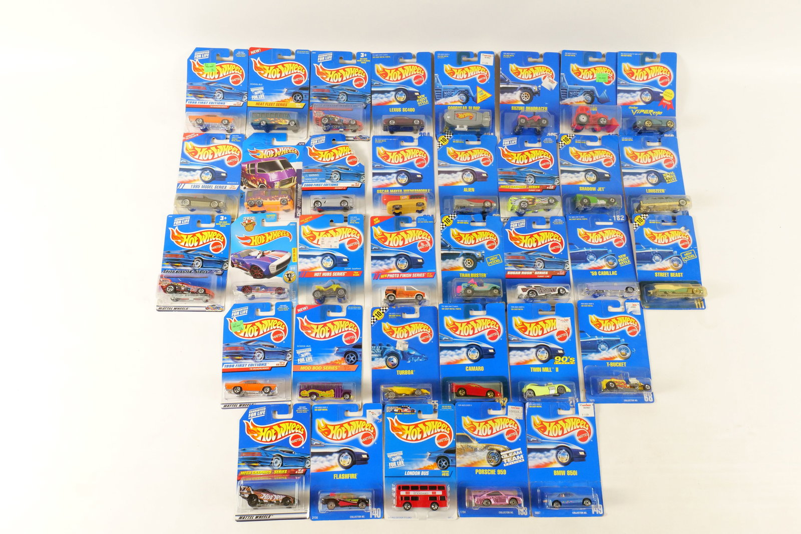 Lot of 35 Carded Hot Wheels: Lot of 35 Carded Hot Wheels. Including GMC Motorhome, '70 Roadrunner, Nitro Doorslammer, Mercedes SL, School Bus, Goodyear Blimp, and More. Some Early 1990's. Includes some duplicates. Some of the car